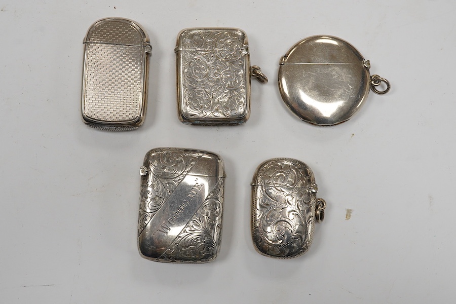 Five assorted late 19th/early 20th century silver vesta cases, including a George V circular case by William Neale Ltd, 45mm and a late Victorian arched by George Unite. Condition - fair